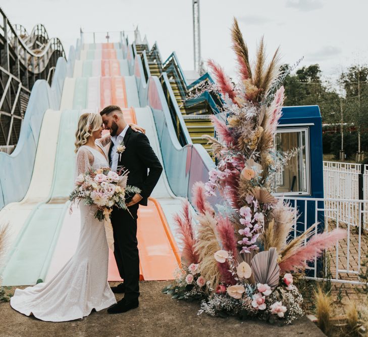 Vertical flower arrangements at Dreamland Margate with pink coloured pampas grass, dried palm leaves, anthuriums and orchids 