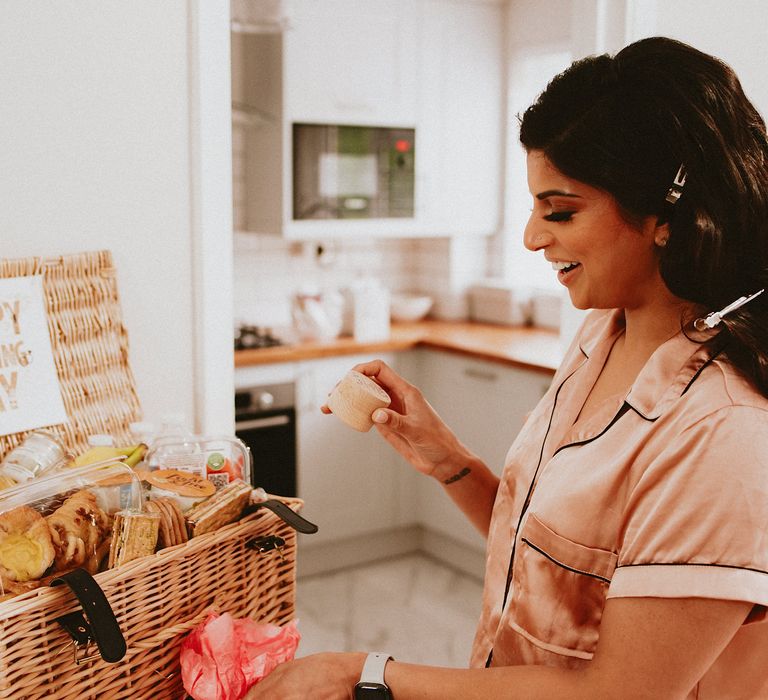 Bride on her the wedding morning with hamper of goodies 