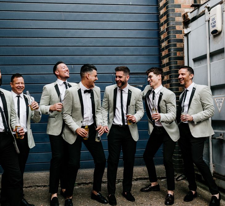 Stylish groomsmen in black trousers and grey blazers at Trinity Buoy Wharf wedding 