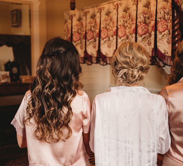 Bride and bridesmaid wedding hairstyles with wavy half up half down styles and pinned up dos 