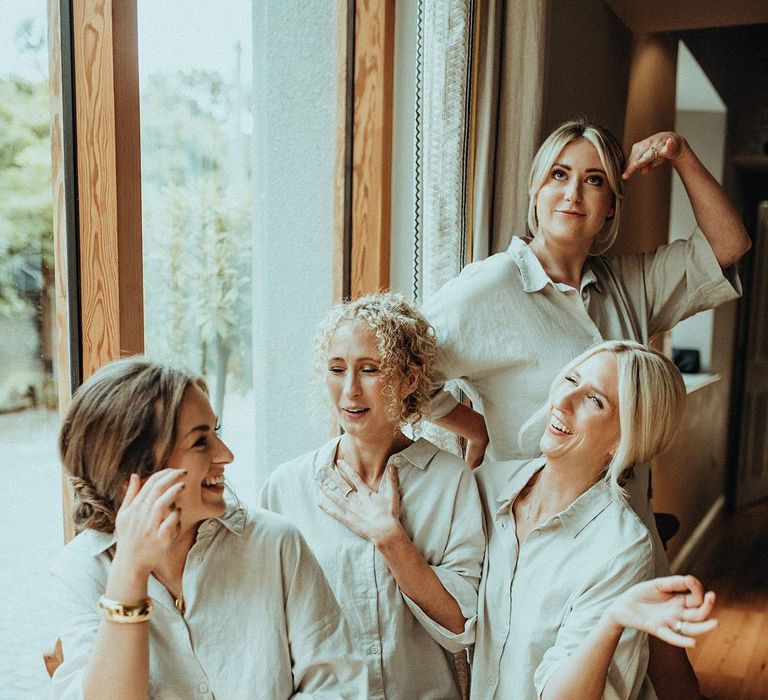 Bridesmaids wear matching light green shorts and shirts on the morning of wedding day