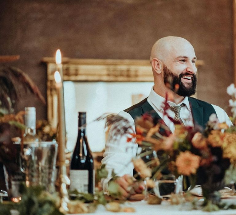 Groom smiles and laughs on his wedding day