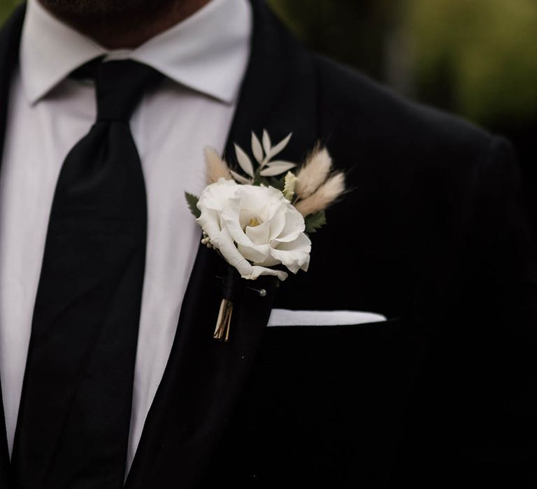 white rose buttonhole with bunny ears for black tie wedding 