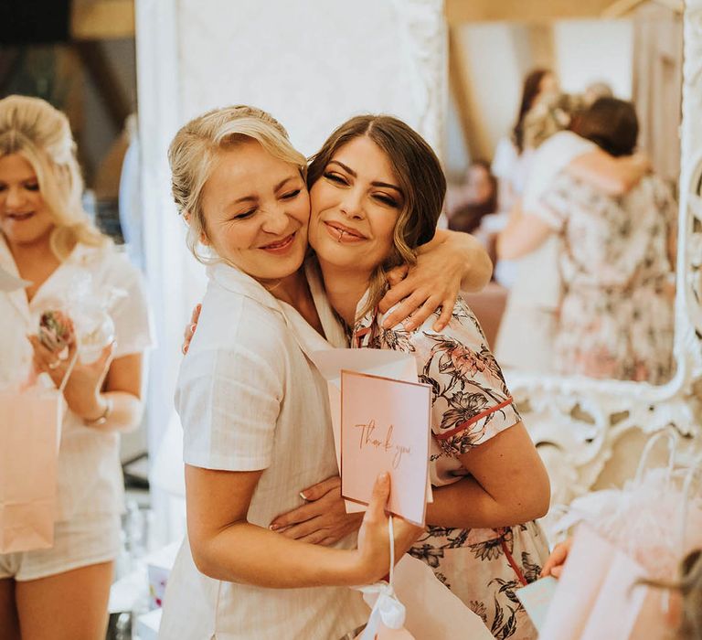 Bride hugs bridesmaid before wedding