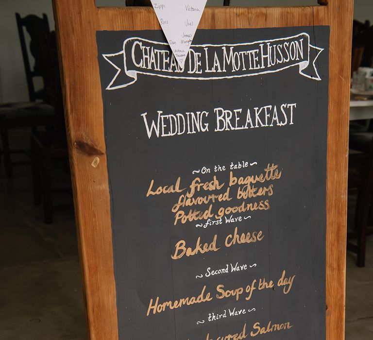 Chateau De La Motte Husson wedding breakfast menu sign on a chalkboard