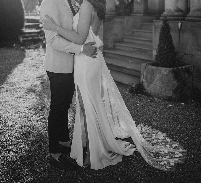 Bride and groom share a kiss at their romantic intimate wedding 