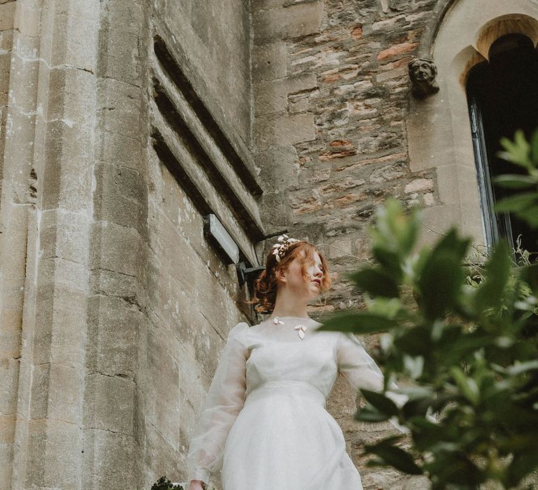 Bride in a sustainable fabric wedding dress with two layers and gold leaf jewellery at Bishop's Palace Wells