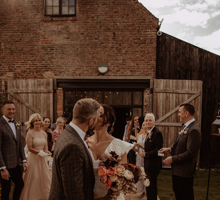 Bride and groom share a kiss together after their civil wedding ceremony 