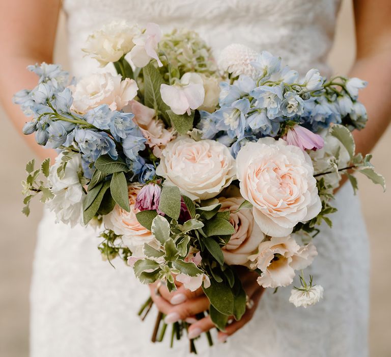 Pastel floral bridal bouquet with roses and green foliage