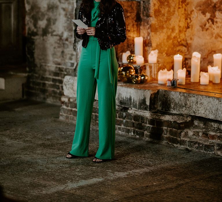 Guest does wedding reading at unique London venue surrounded by candles for wedding lighting