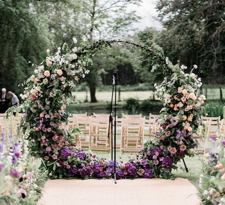 Deep purple and peach wedding moongate decorating the altar for outdoor wedding ceremony 