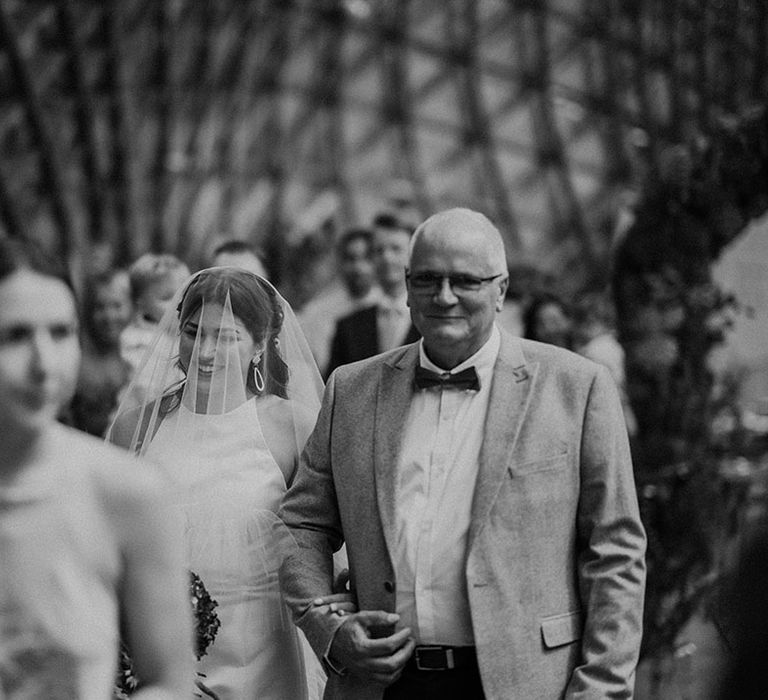 Father of the bride walks the bride down the aisle for the wedding baptism at The Gridshell 