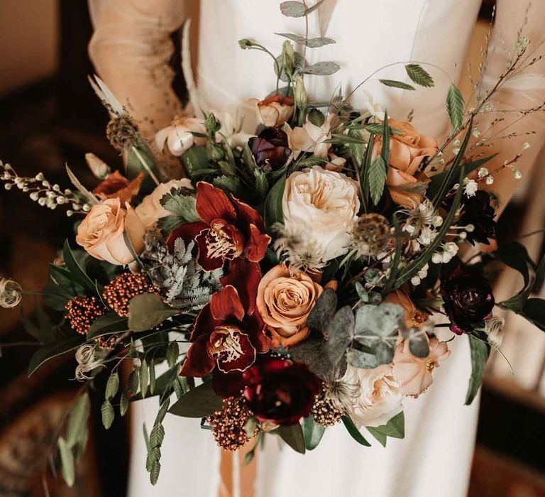 Mixed neutral toned floral and foliage bouquet with garden roses, carnations, peonies, eucalyptus, baby's-breath and dried flowers tied with mustard velvet ribbon 