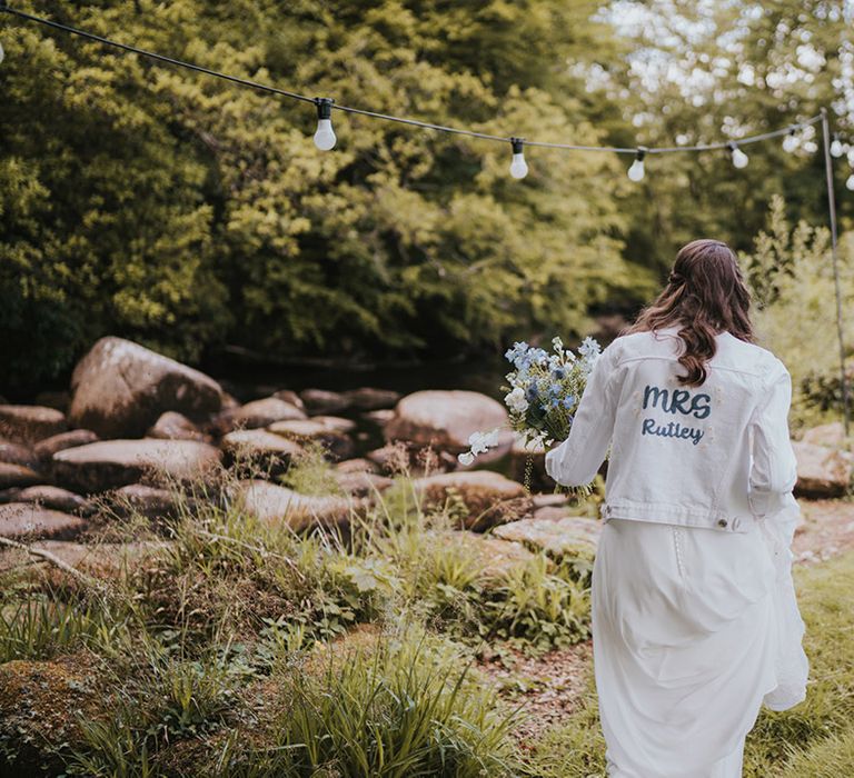 White denim jacket with DIY design on the back of the bride's new last name 