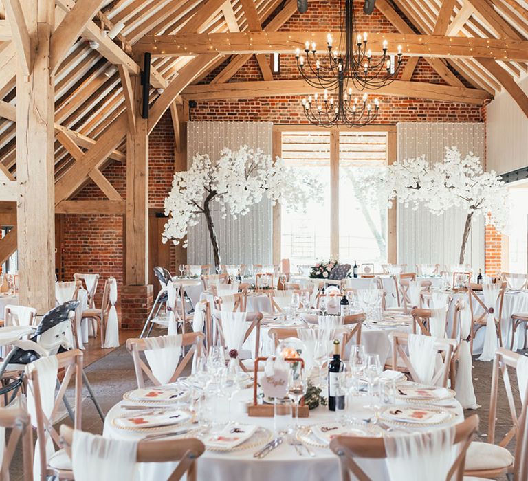 Pink and white neutral theme colour palette with blossom tree decorations with original wood beams 