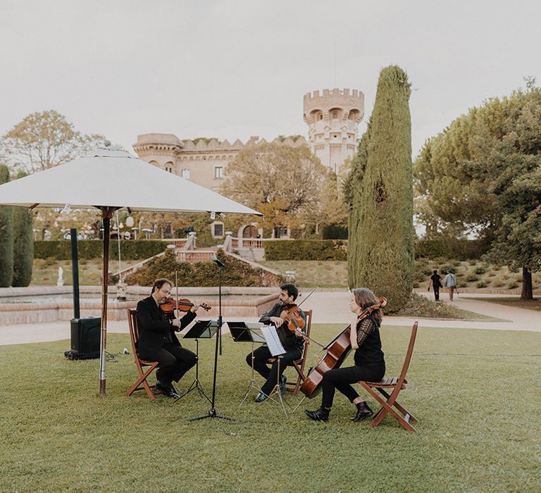 Live string wedding band on the grounds of Barcelona castle wedding venue 