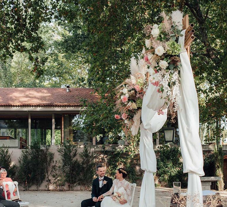 aisle wedding decor with drapes, lanterns and dried flowers 