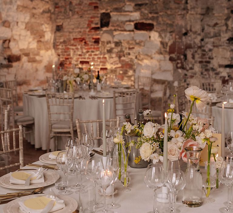 Spring wedding with pastel yellow and white wedding table decor with wildflower table arrangements 