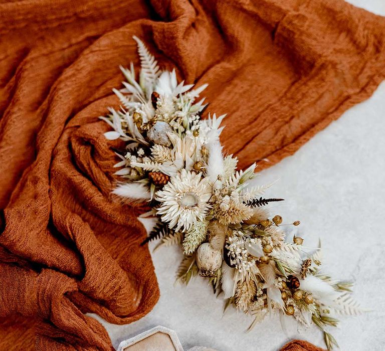 preserved flower hair slide on orange drape