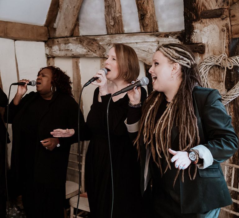 Gospel choir in black outfits singing at the ceremony at Colville Hall