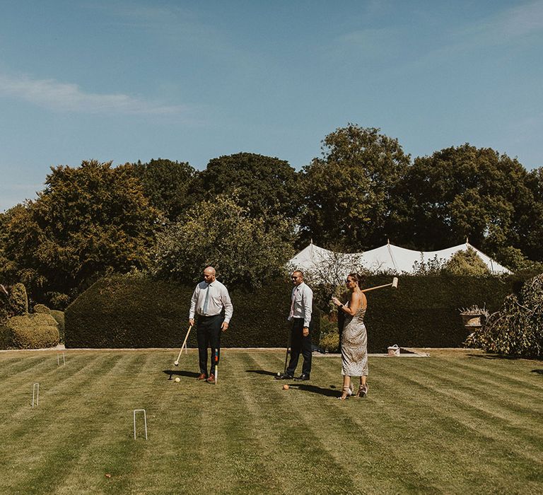 Wedding guests playing croquet wedding games 