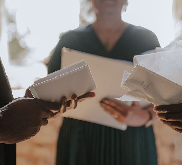 The bride and groom reading out their wedding vows at their ceremony 