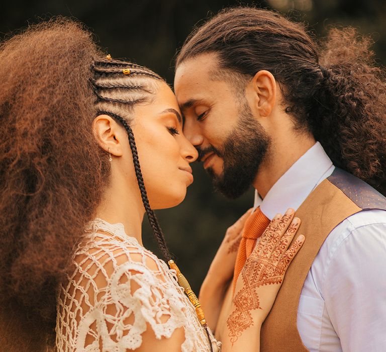 Bride in boho crochet wedding dress from Poppy Perspective with the groom in brown waistcoat at Woodstock wedding inspiration 