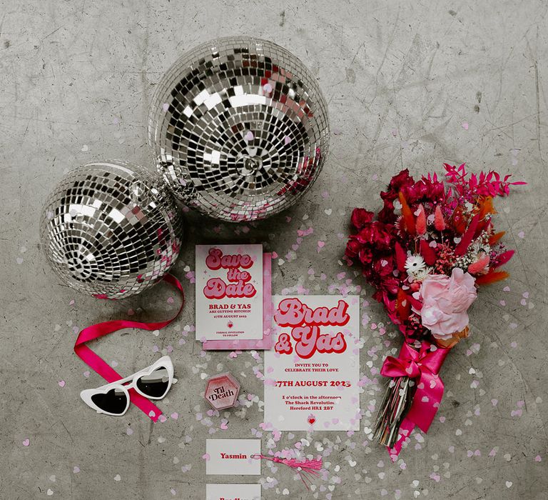 Pink dried flowers and disco balls with retro pink wedding stationery 