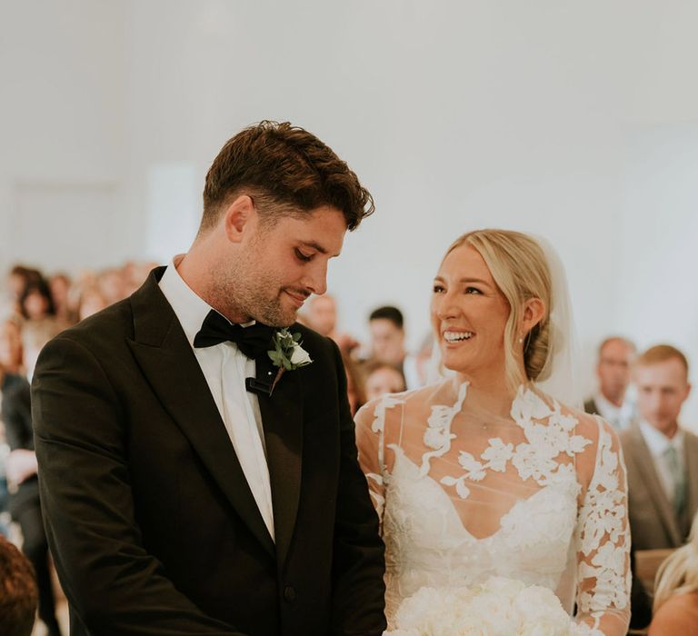 The bride an groom in black tie at their wedding ceremony 