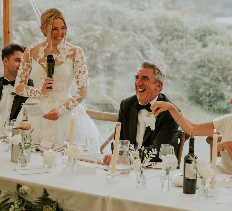 Bride stands up to read her bridal speech at the wedding 