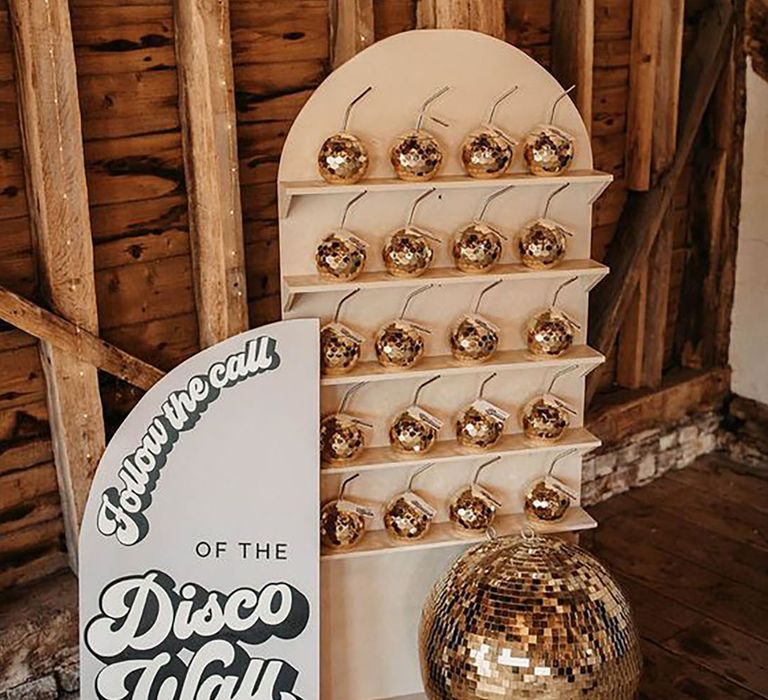 Disco ball drink station with disco ball shaped cups at wedding by Olegs & Rita Photography