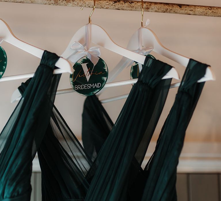 Personalised dark green hangers for the bridesmaid's dresses 