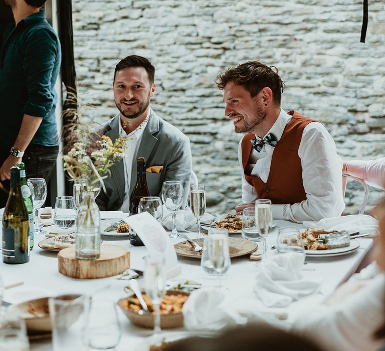 Two grooms at their wedding breakfast enjoying a Egyptian themed wedding feast 