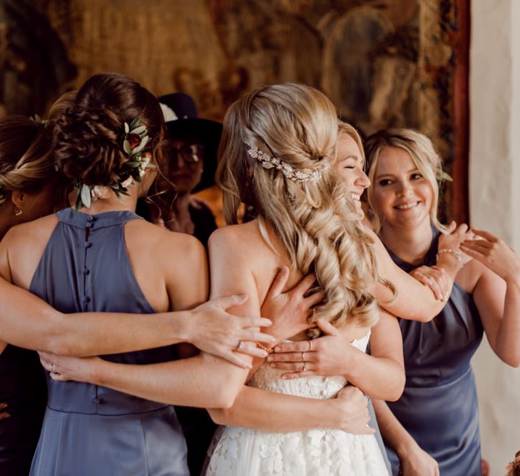 Bridal party hug before ceremony