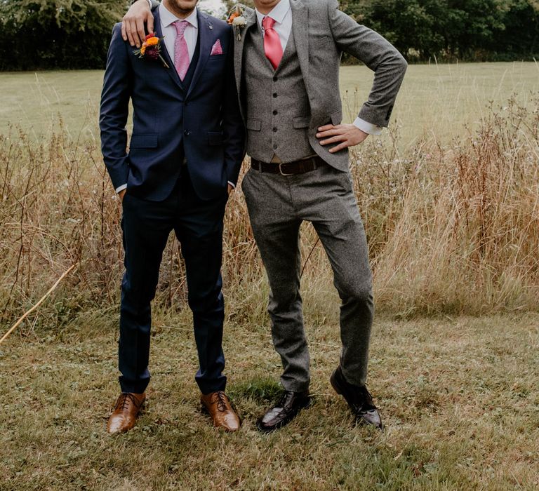 Groom and groomsman in navy and grey suits