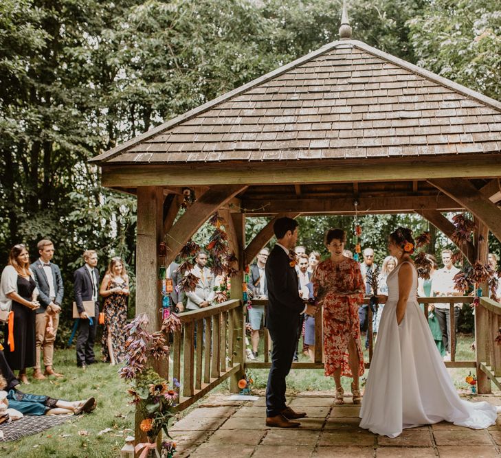 Outdoor wedding ceremony with vibrant wedding decor 