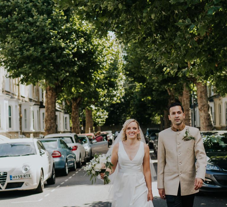 Bride and groom walking through the streets 