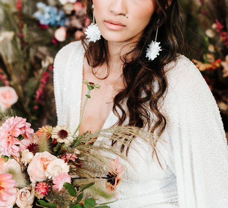 Asian bride wearing a sequin wedding dress and chandelier earrings 