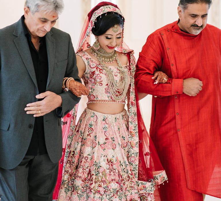 Bride being given away by the males in her family during Hindu wedding ceremony 