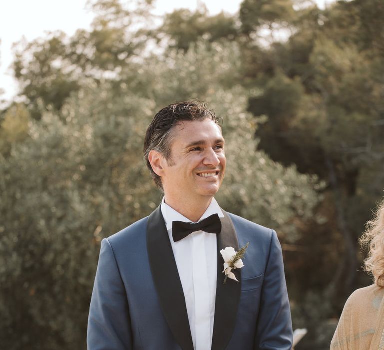 Groom in navy tuxedo with black lapel 