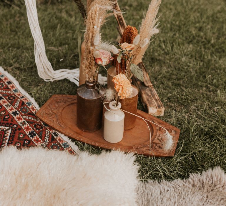 Vases filled with floral decoration outdoors 