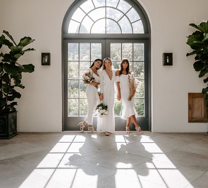 Bridesmaids in white dress standing in The Fig House at Middleton Lodge 