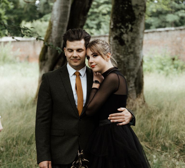 Bride wears black long sleeved wedding dress