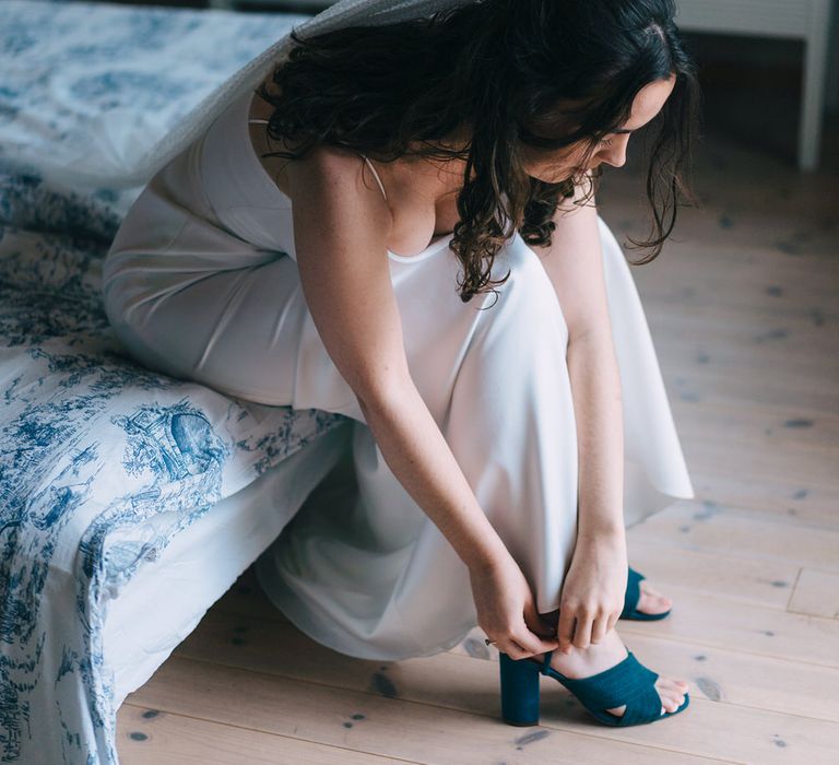 Bride wearing blue shoes from Zara, a micro dot veil from AM Faulkner and a dress by Sarah Seven