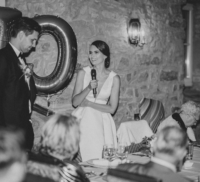 Bride in white Jesus Piero wedding dress making a speech at rural German wedding