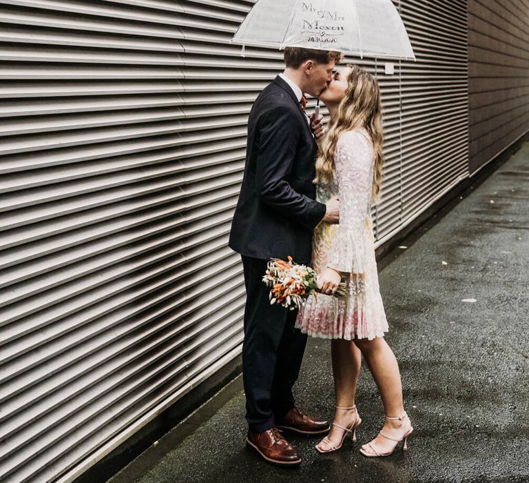 Bride and groom wedding day photography in the rain 