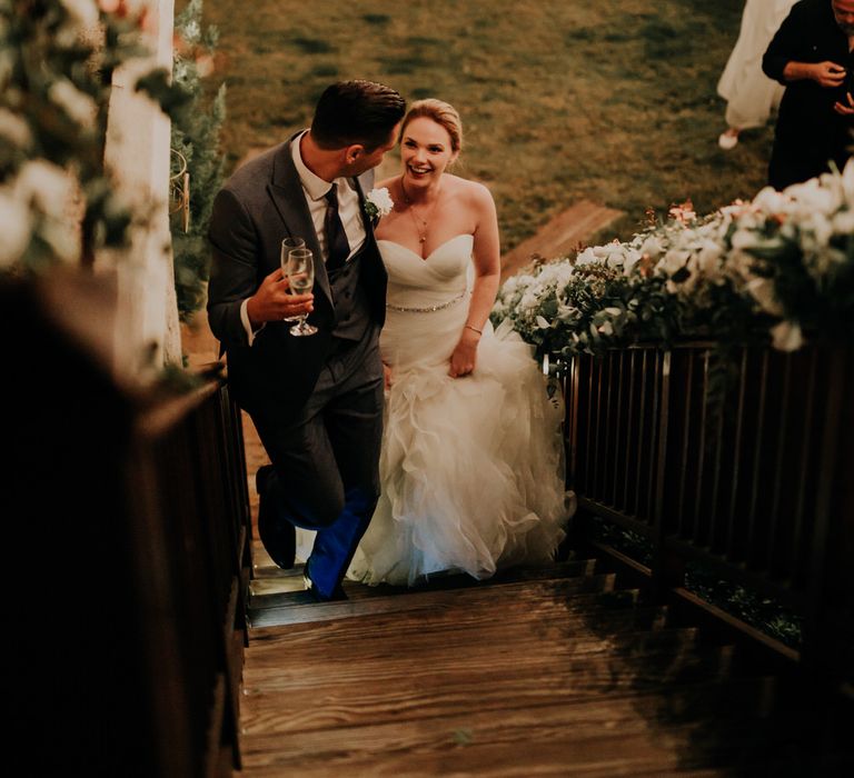 The bride and groom sharing a moment walking up the stairs together