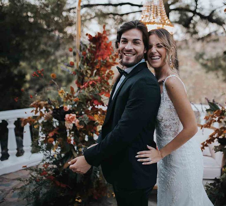 Bride and groom smile at intimate elopement