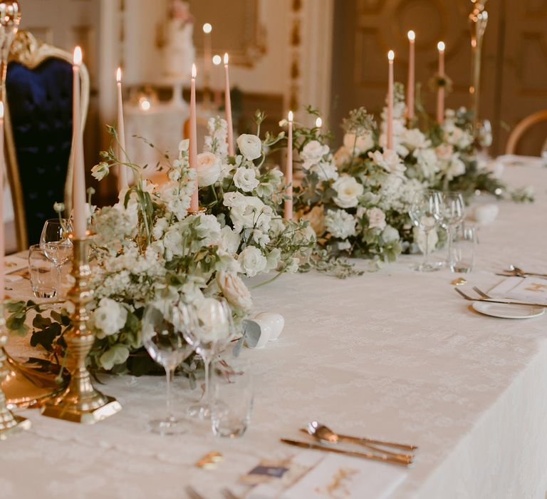 Tablescape at Markree Castle filled with white and green floral bouquets and pink candlesticks 