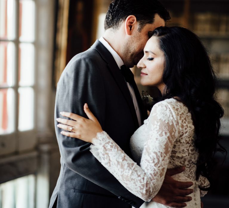 Bride & groom embrace lovingly 